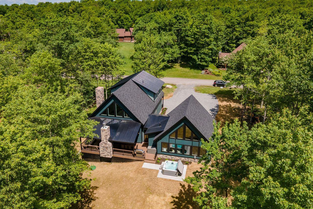 Adirondack — aerial view of the home on its wooded lot