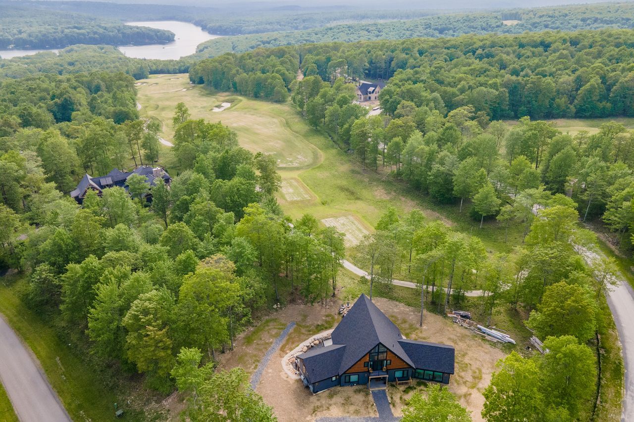 Aerial view of Deep Creek Lake with a Cabine home in the trees