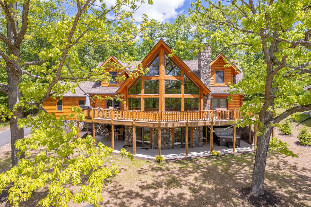 Lindal log home with a wraparound deck in the trees