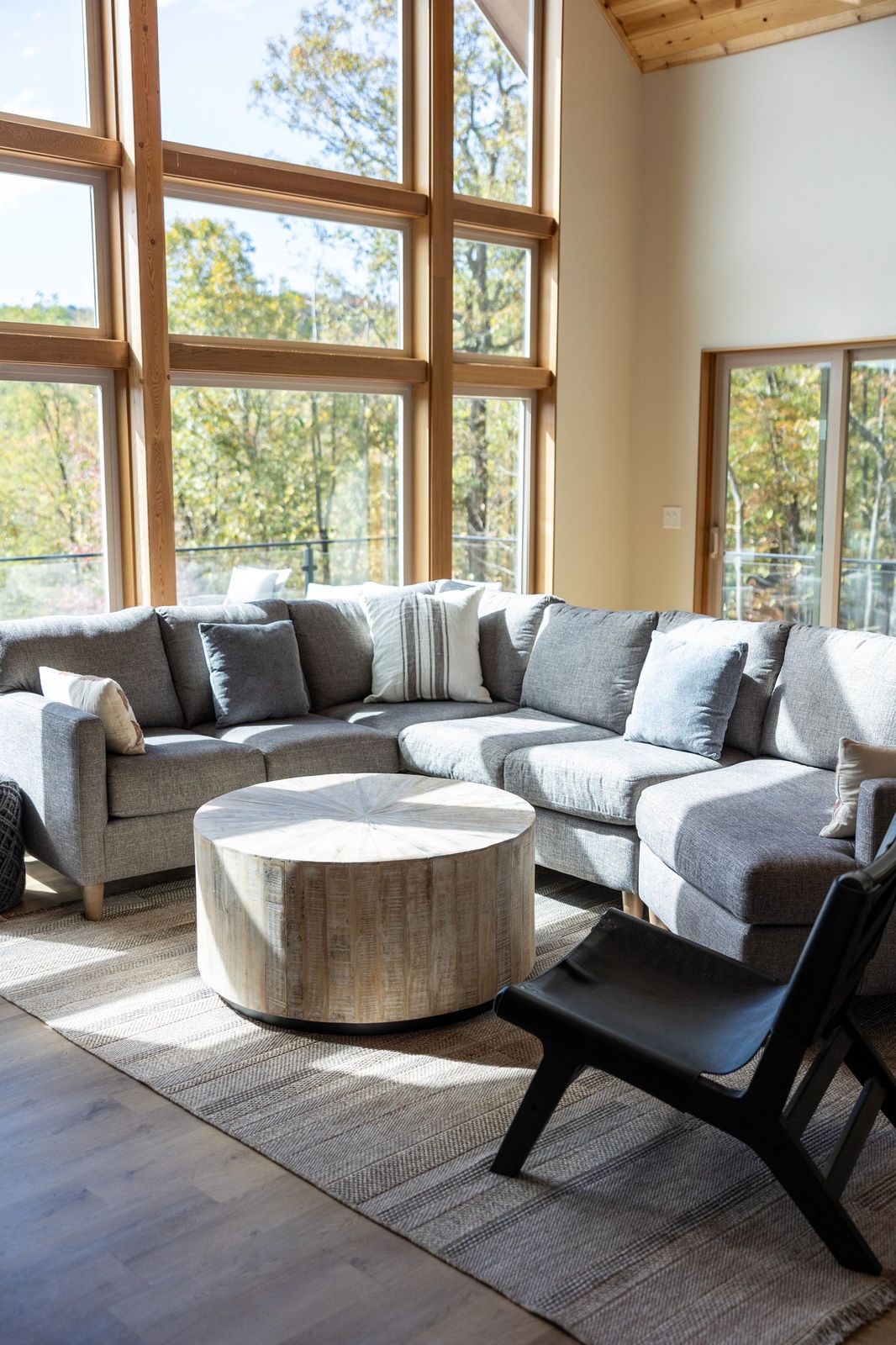 Living room below a two-story window wall